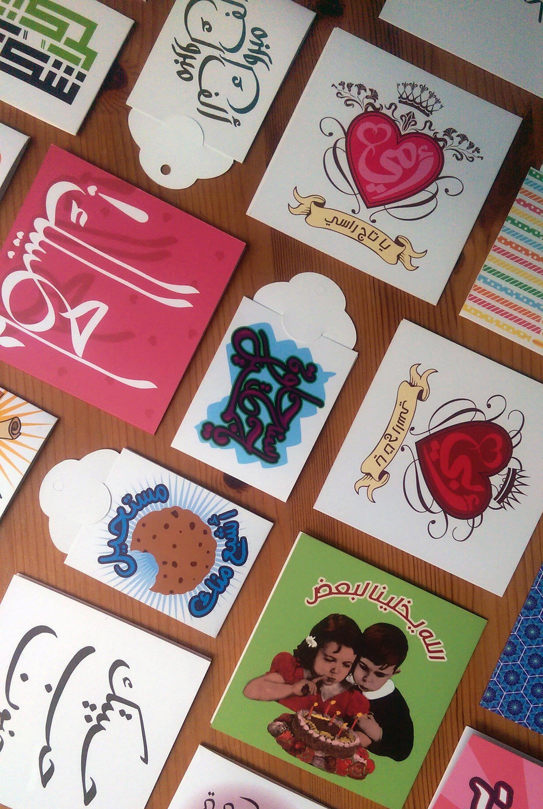 Collection of various cards with different designs on a wooden surface